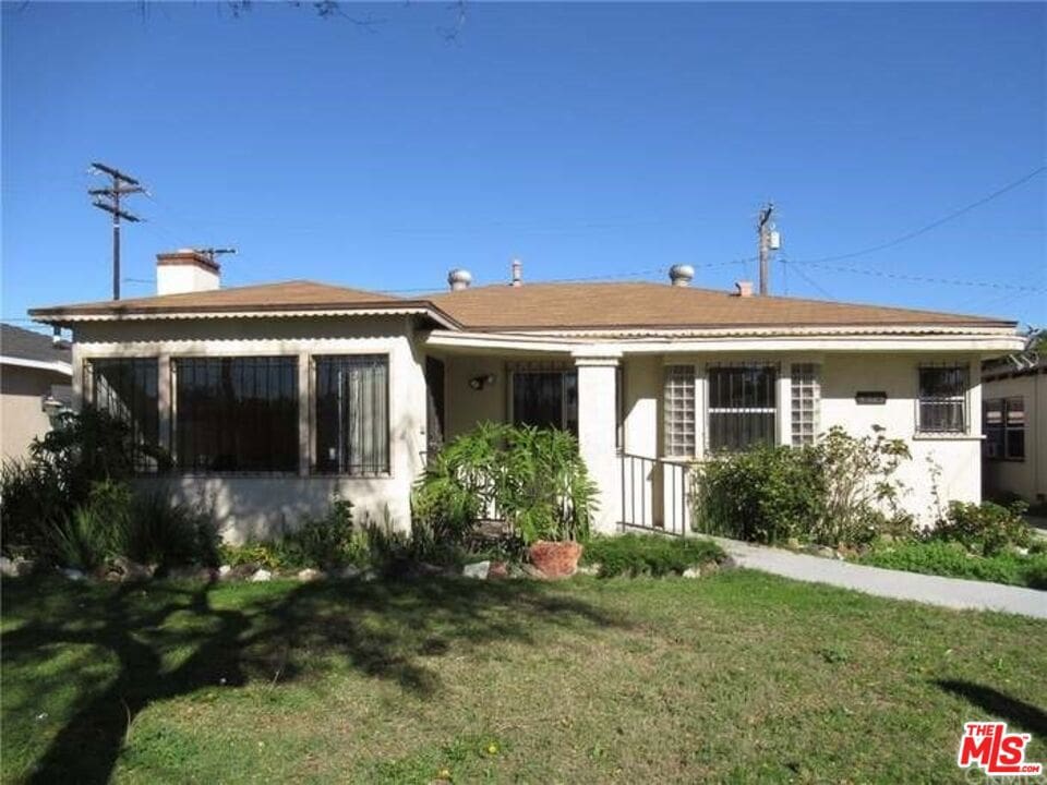 rear view of house with a lawn