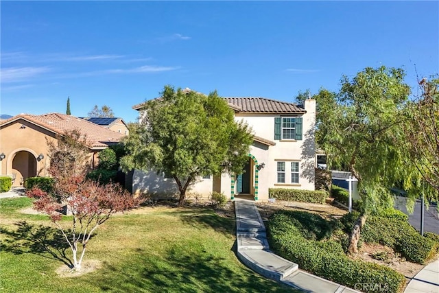 mediterranean / spanish-style house with a front lawn