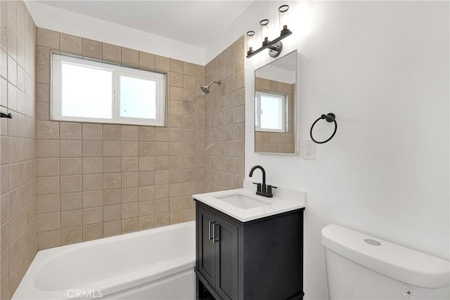 full bathroom with vanity, toilet, and tiled shower / bath