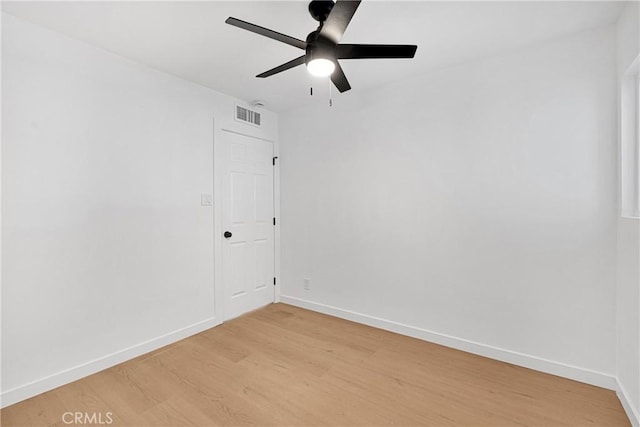 spare room featuring hardwood / wood-style floors and ceiling fan