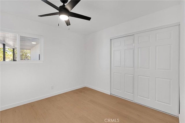 unfurnished bedroom featuring a closet, light hardwood / wood-style flooring, and ceiling fan