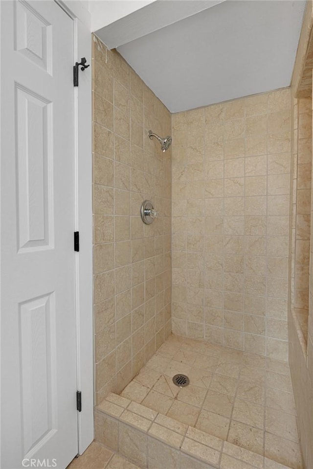 bathroom with a tile shower