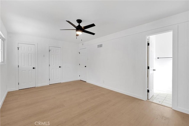 unfurnished room with ceiling fan and light wood-type flooring