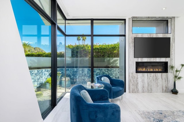 interior space with a wall of windows and a fireplace