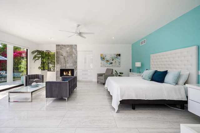 bedroom featuring ceiling fan and a fireplace