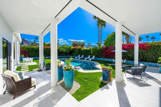 view of patio with a fenced in pool