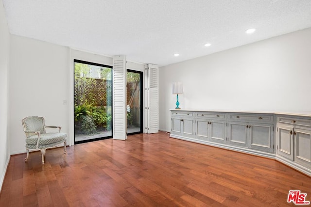 spare room with light hardwood / wood-style floors and a textured ceiling