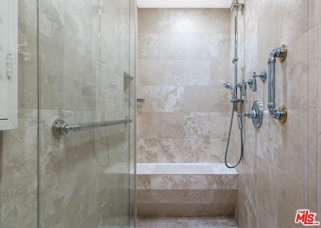 bathroom with tiled shower