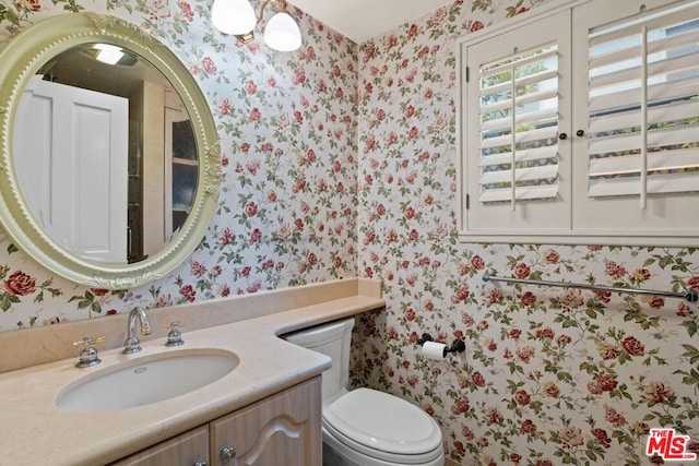 bathroom featuring vanity and toilet