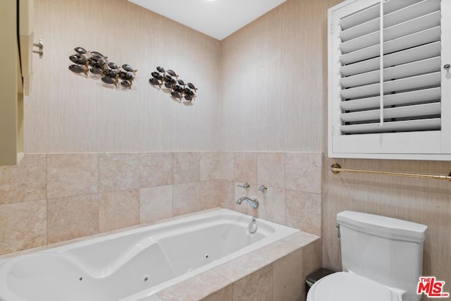 bathroom featuring a relaxing tiled tub and toilet