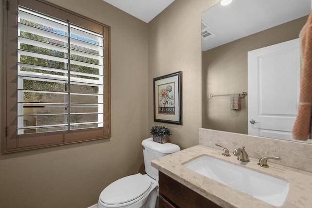 bathroom featuring toilet and vanity