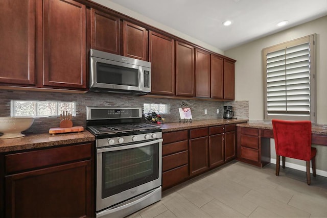 kitchen with stainless steel appliances, a healthy amount of sunlight, tasteful backsplash, and dark stone counters