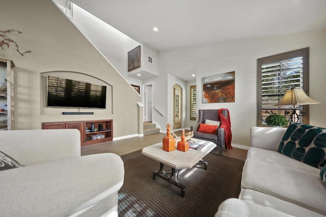 living room with built in features and lofted ceiling