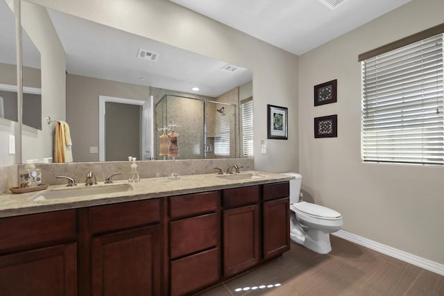 bathroom featuring vanity, toilet, hardwood / wood-style flooring, and walk in shower