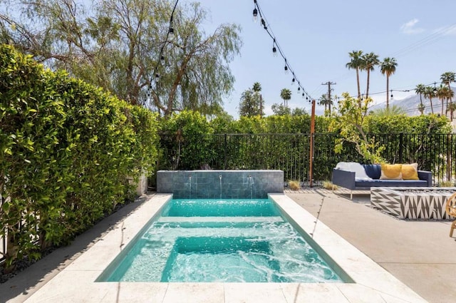 view of swimming pool featuring pool water feature and a patio