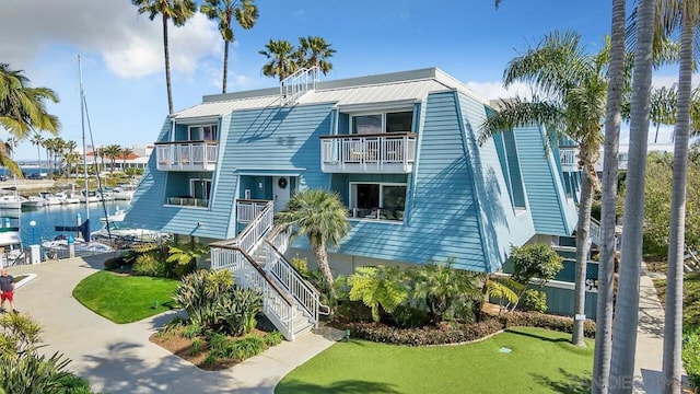 raised beach house featuring a water view