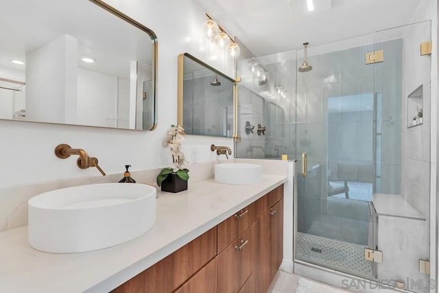 bathroom with vanity and a shower with shower door