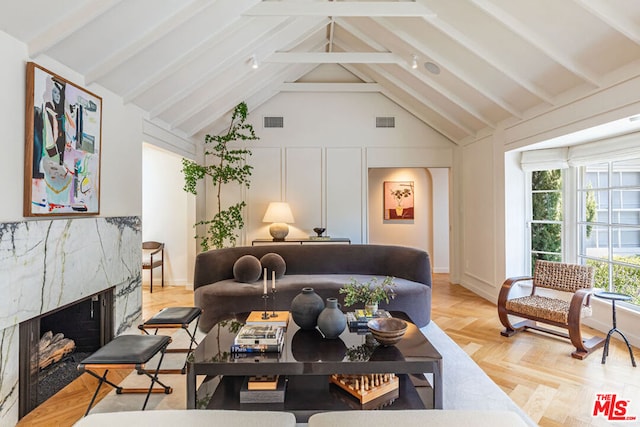 living room with beam ceiling, a fireplace, high vaulted ceiling, and light parquet floors