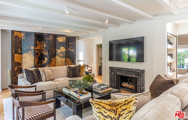 living room featuring a fireplace and beamed ceiling