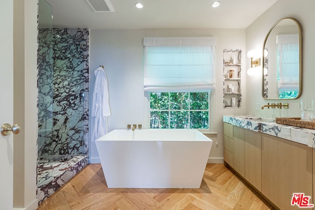 bathroom with vanity, parquet floors, and independent shower and bath