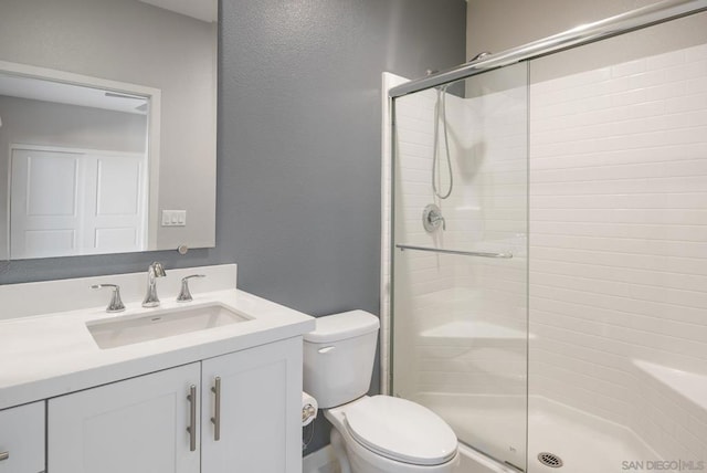 bathroom with vanity, toilet, and walk in shower