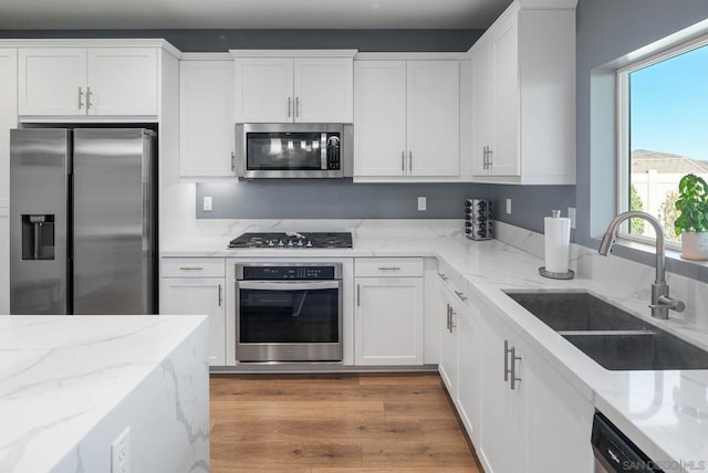 kitchen with white cabinets, sink, and appliances with stainless steel finishes