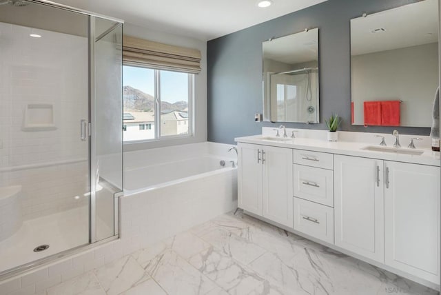 bathroom featuring separate shower and tub, a mountain view, and vanity