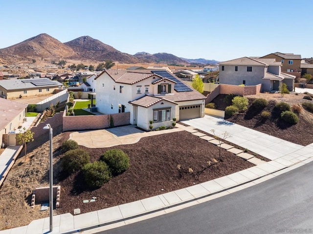 view of front of property featuring a mountain view and a garage