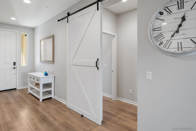 interior space featuring a barn door and light wood-type flooring