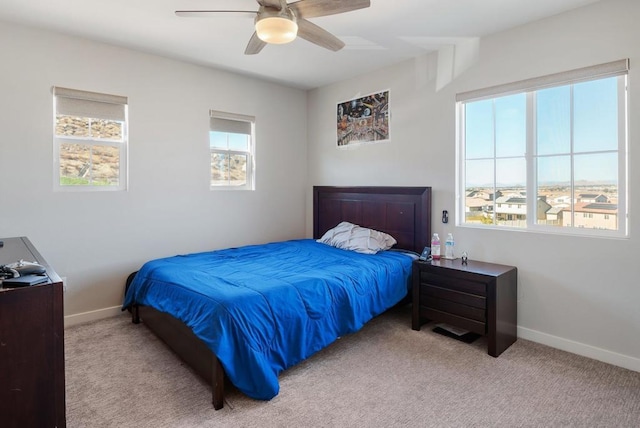 bedroom featuring light carpet and ceiling fan