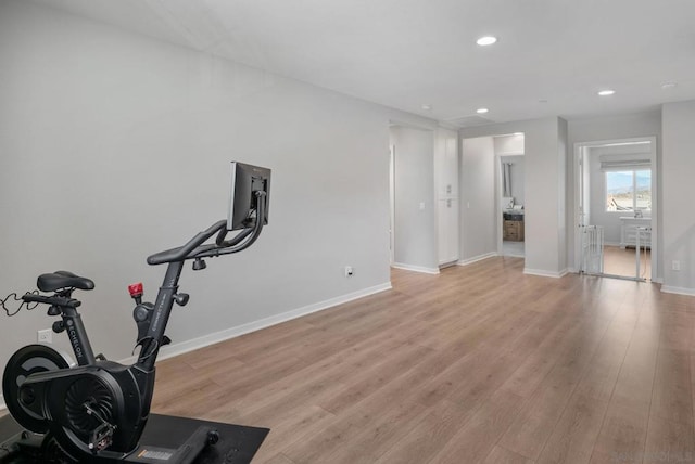 workout room with light hardwood / wood-style flooring