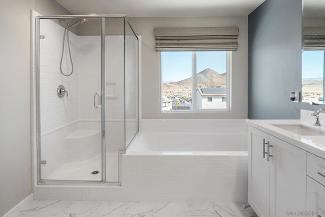 bathroom featuring a mountain view, vanity, and separate shower and tub