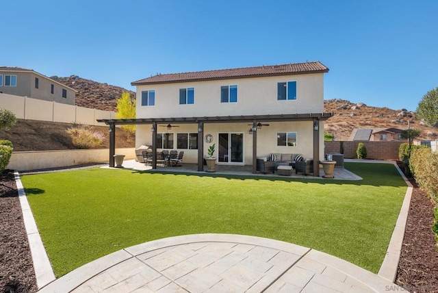 rear view of house with ceiling fan, central AC, an outdoor hangout area, a mountain view, and a patio