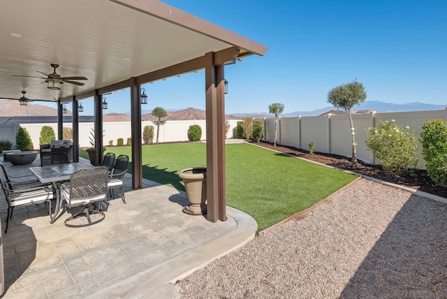 view of patio / terrace with a mountain view and ceiling fan