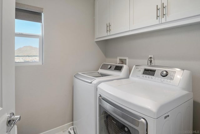 laundry room featuring cabinets and separate washer and dryer