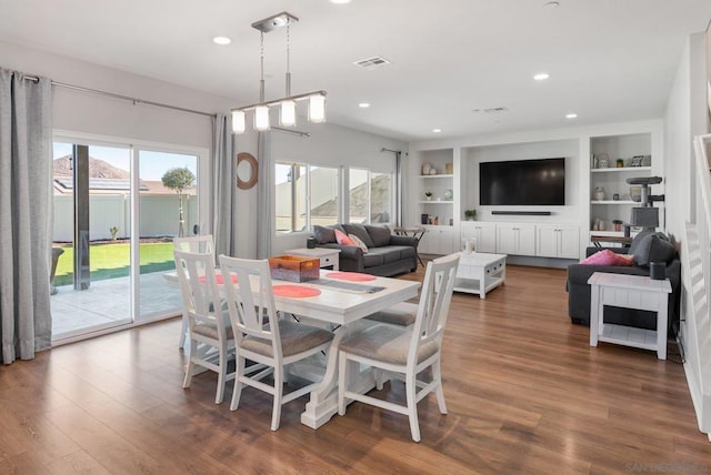 dining room with built in features and dark wood-type flooring