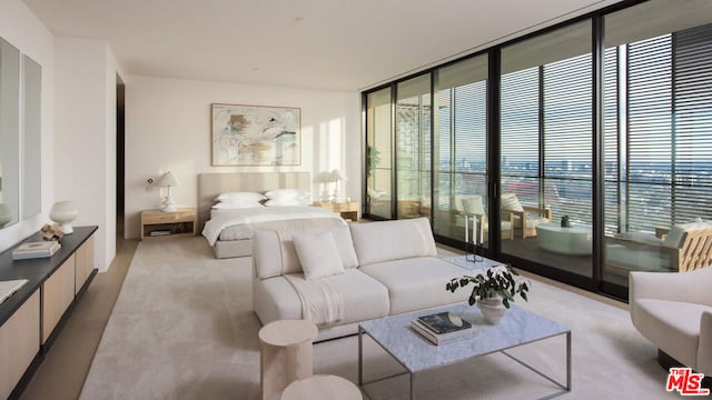 bedroom featuring expansive windows, access to outside, and multiple windows