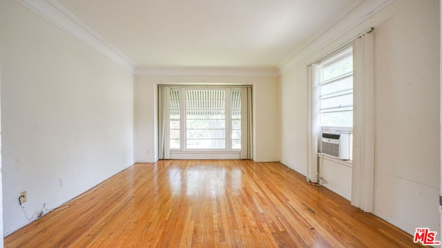 unfurnished room featuring crown molding, cooling unit, and light hardwood / wood-style floors