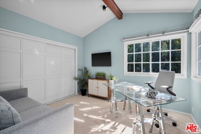 carpeted office space featuring lofted ceiling with beams