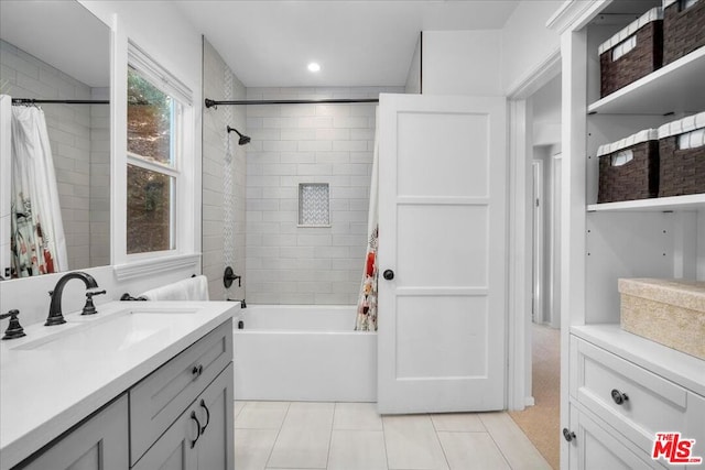 bathroom featuring tile patterned flooring, shower / bath combo, and vanity