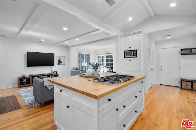 kitchen featuring white cabinetry, wood counters, light hardwood / wood-style flooring, lofted ceiling with beams, and appliances with stainless steel finishes