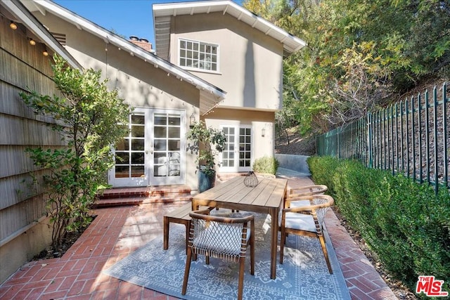 back of property featuring a patio area and french doors