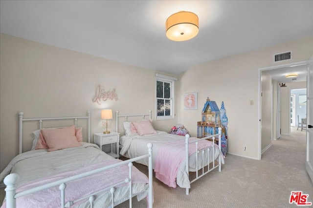 bedroom featuring light carpet and multiple windows