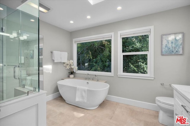 full bathroom with tile patterned flooring, vanity, separate shower and tub, and toilet