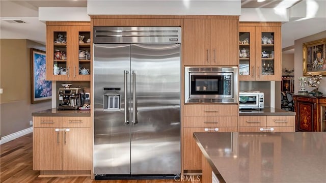 kitchen featuring hardwood / wood-style floors and built in appliances