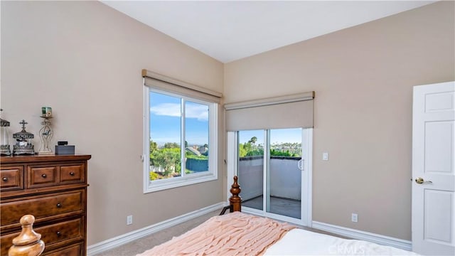 bedroom with access to exterior and light colored carpet