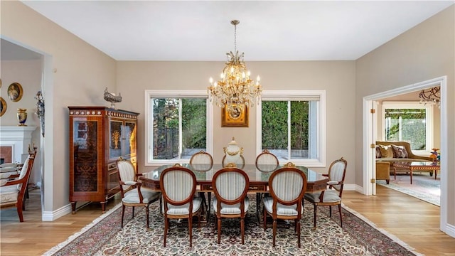 dining area with wood-type flooring and an inviting chandelier