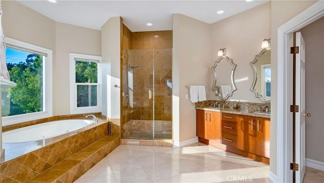 bathroom featuring tile patterned flooring, vanity, independent shower and bath, and a wealth of natural light