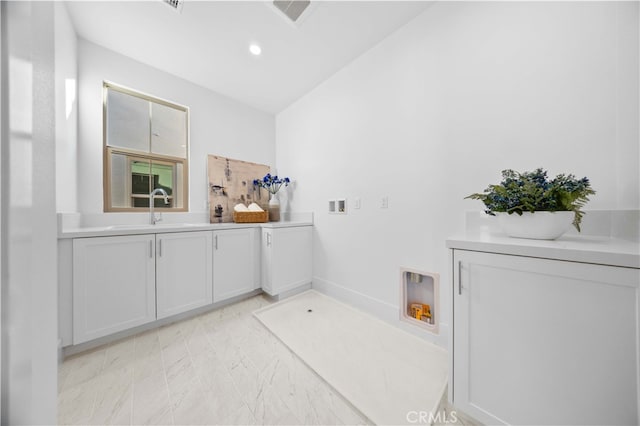 bathroom with vanity and lofted ceiling