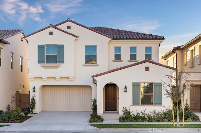 mediterranean / spanish house featuring a garage